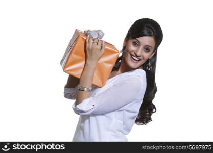 Portrait of a woman holding a gift box