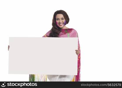 Portrait of a woman holding a white board