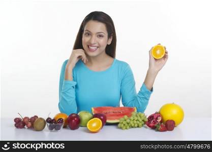 Portrait of a woman holding an orange