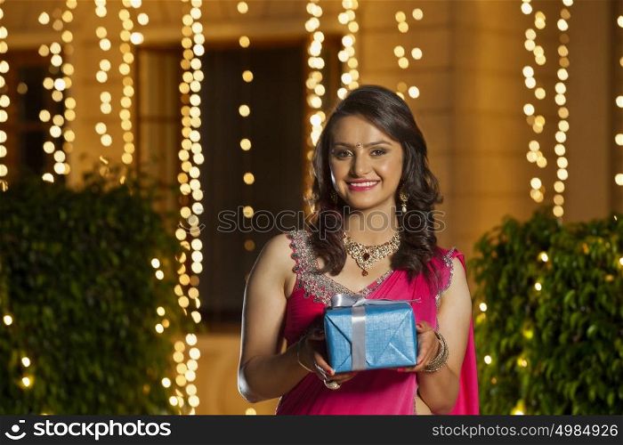 Portrait of a woman holding gift