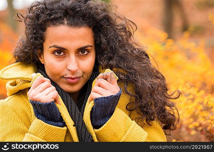 Portrait of a woman holding her coat autumn nature background