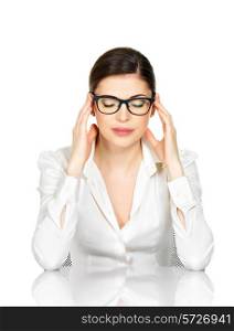 Portrait of a woman in glasses with strong headache. Business woman in white office shirt sits from the table - isolated on white background&#xA;