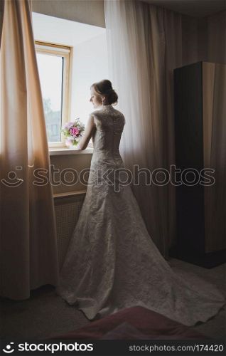 Portrait of a woman in long wedding dress.. Wedding dress with large plume 3755.