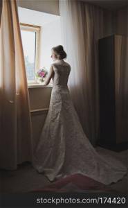 Portrait of a woman in long wedding dress.. Wedding dress with large plume 3755.