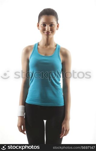 Portrait of a woman in sportswear standing against white background