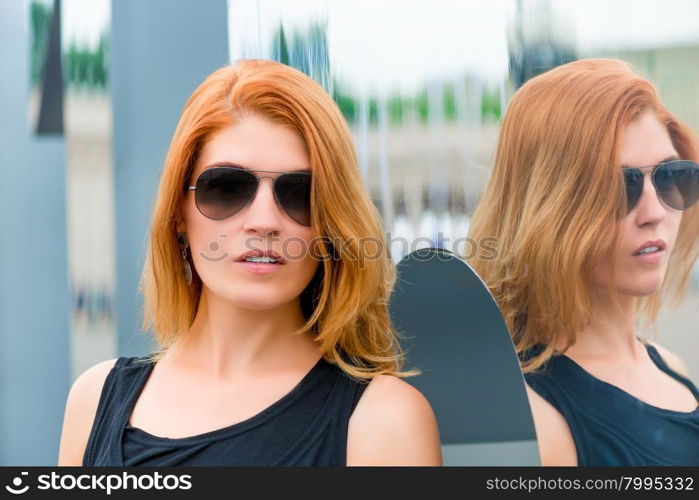 portrait of a woman in sunglasses in the city