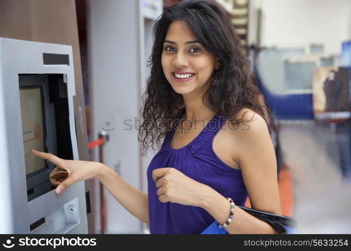 Portrait of a woman next to an ATM machine