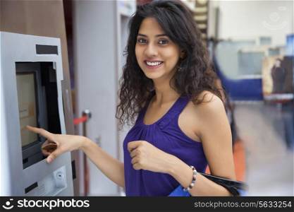 Portrait of a woman next to an ATM machine
