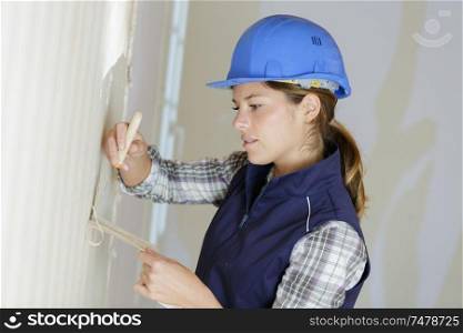 portrait of a woman removing wall paper