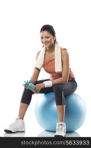 Portrait of a woman sitting on a exercise ball