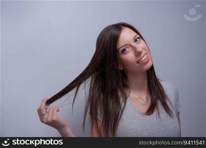 Portrait of a woman touching her hair like if it’s damaged
