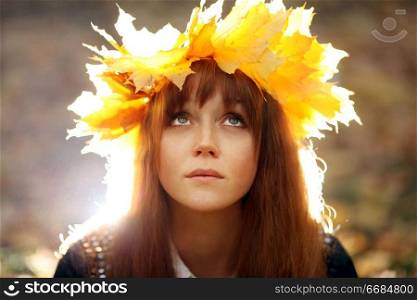 portrait of a woman wearing a wreath of maple leaves