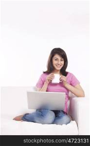 Portrait of a woman with a mug of tea and laptop