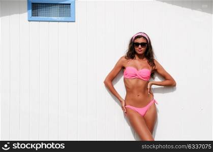 Portrait of a woman with beautiful body in a beach hut