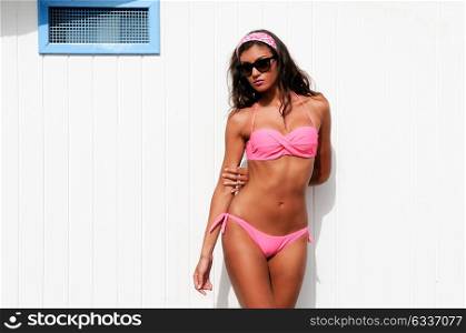 Portrait of a woman with beautiful body in a beach hut