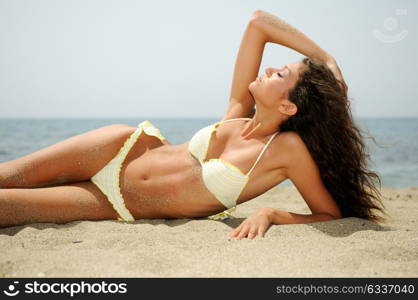 Portrait of a woman with beautiful body on a tropical beach