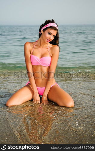 Portrait of a woman with beautiful body on a tropical beach