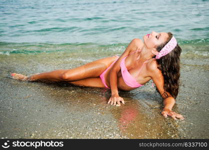 Portrait of a woman with beautiful body on a tropical beach