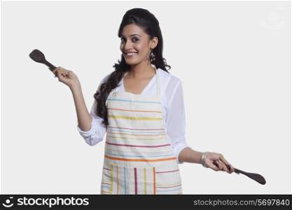 Portrait of a woman with cooking utensils