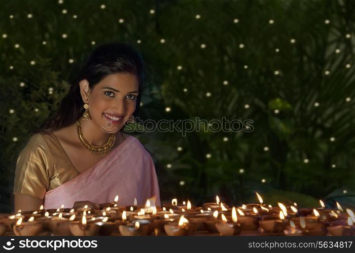 Portrait of a woman with diyas