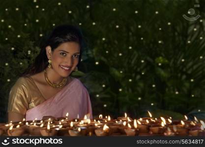 Portrait of a woman with diyas