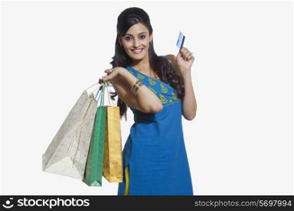 Portrait of a woman with shopping bags and credit card