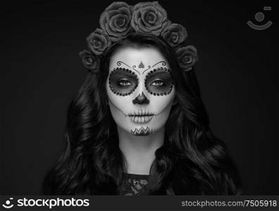 Portrait of a woman with sugar skull makeup over black background. Halloween costume and make-up. Black and white Portrait of Calavera Catrina