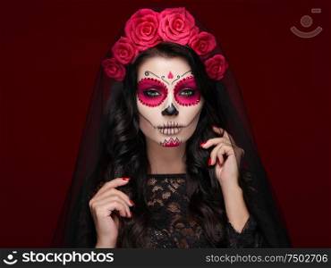 Portrait of a woman with sugar skull makeup over red background. Halloween costume and make-up. Portrait of Calavera Catrina