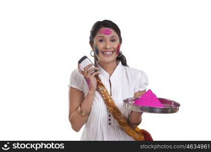 Portrait of a WOMEN with holi colour and mobile phone