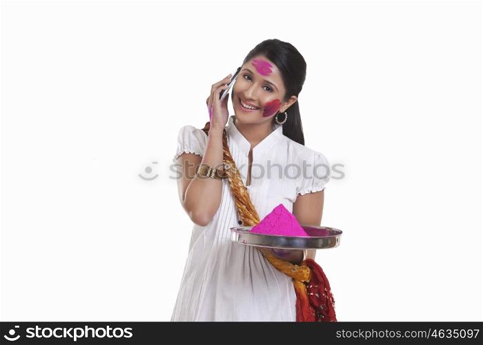 Portrait of a WOMEN with holi colour talking on a mobile phone