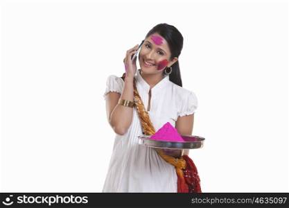 Portrait of a WOMEN with holi colour talking on a mobile phone