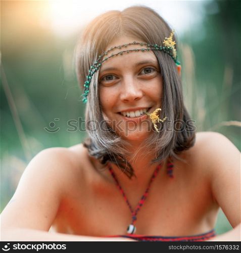 Portrait of a Woodstock Hippie style girl. With flower in the mouth. deliberately vintage photograph