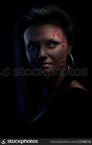 Portrait of a wounded young woman in low key