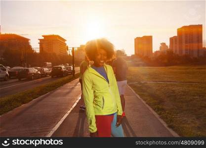 portrait of a young African American girl to run beautiful summer morning on city streets