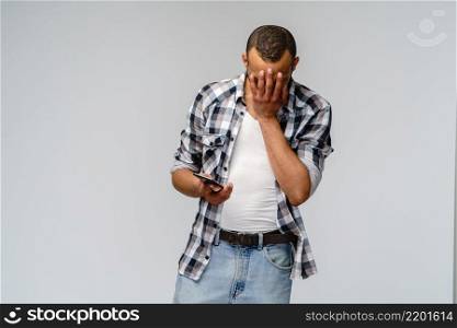Portrait of a young african american man holding mobile cell phone.. Portrait of a young african american man holding mobile cell phone