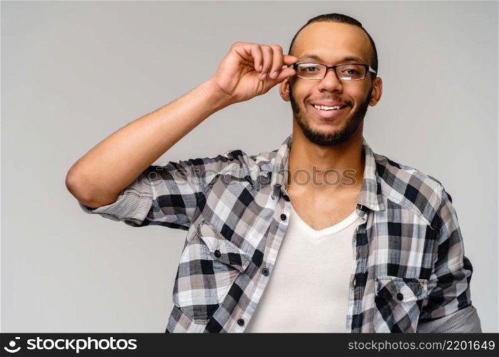 Portrait of a young african american over light grey background.. Portrait of a young african american over light grey background