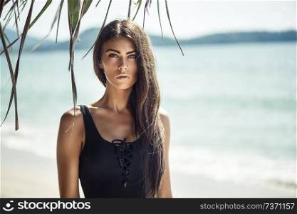 Portrait of a young, alluring woman on a tropical beach
