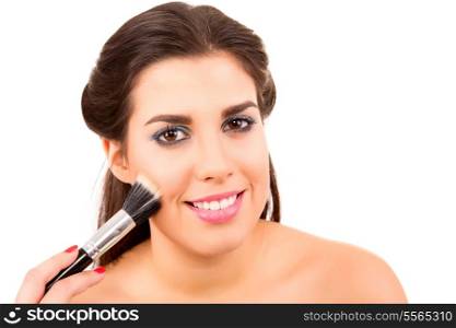 Portrait of a young and beautiful makeup artist with brushes
