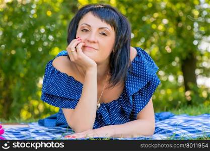 Portrait of a young and beautiful woman on a sunny day in the park