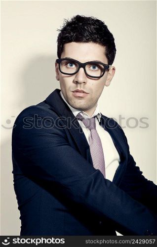 Portrait of a young and fashion businessman with nerd glasses