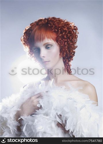 Portrait of a young angelic woman with red hair
