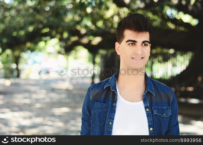 Portrait of a young asian man. Outdoors. Urban concept.