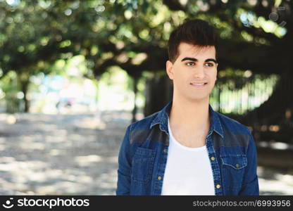 Portrait of a young asian man. Outdoors. Urban concept.