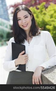 Portrait of a young Asian woman, lawyer or businesswoman smiling at a friend or colleague