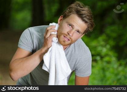 portrait of a young athletic man with workout towel