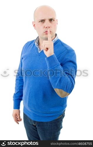 portrait of a young bald man making a shushing gesture with his finger, isolated on a white studio background.