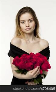 Portrait of a young beautiful blonde girl with a bouquet of red roses, isolated on white background
