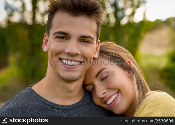 Portrait of a young beautiful couple hugged together