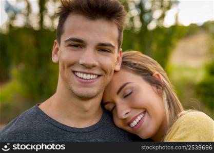 Portrait of a young beautiful couple hugged together
