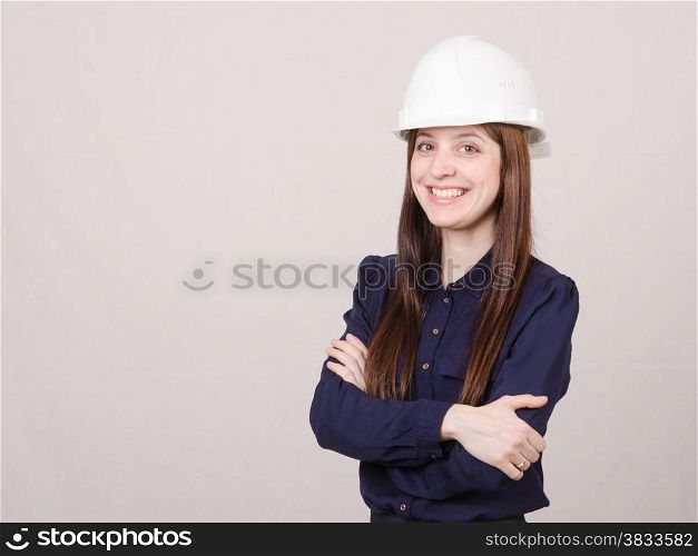 Portrait of a young beautiful girl engineer, architect in helmet